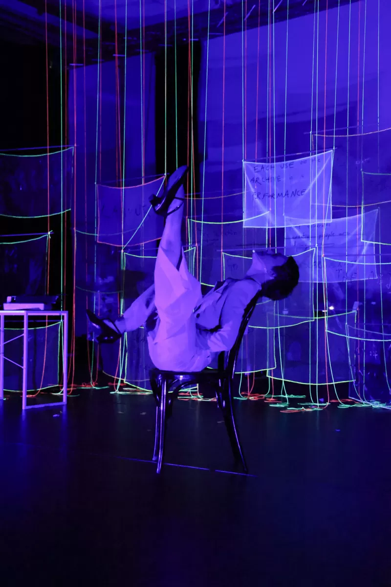 Britta performing the chair dance in blacklight, Tanzfabrik Berlin, June 2021 – photo by Anja Weber