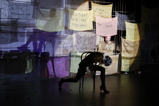 Britta performing the chair dance with William watching while sitting in Margaret and Justine's video projection, Tanzfabrik Berlin, June 2021 – photo by Anja Weber