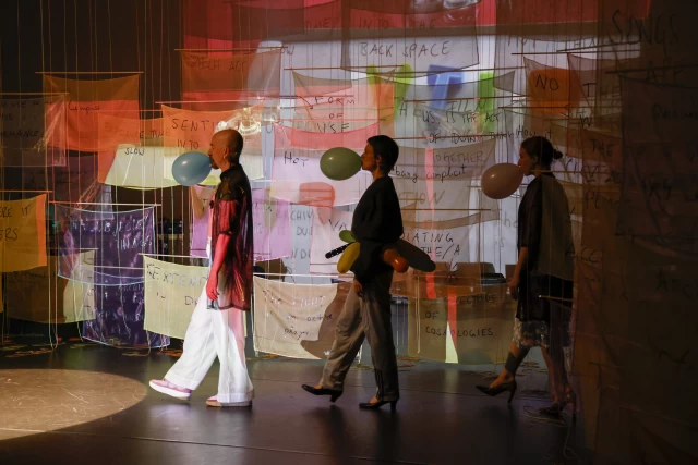 William, Britta and Kasia performing the vivat academia dance, with projection of Justine and Margaret's video 'Jazz Shoulder V-TIP', Tanzfabrik Berlin, June 2021 – photo by Anja Weber