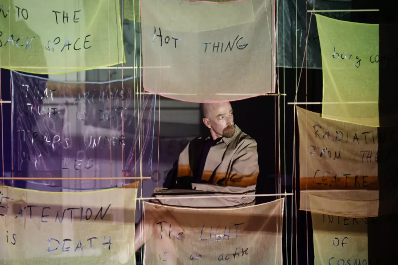 William peeping while sitting in Justine and Margaret's video projection, Tanzfabrik Berlin, June 2021 – photo by Anja Weber