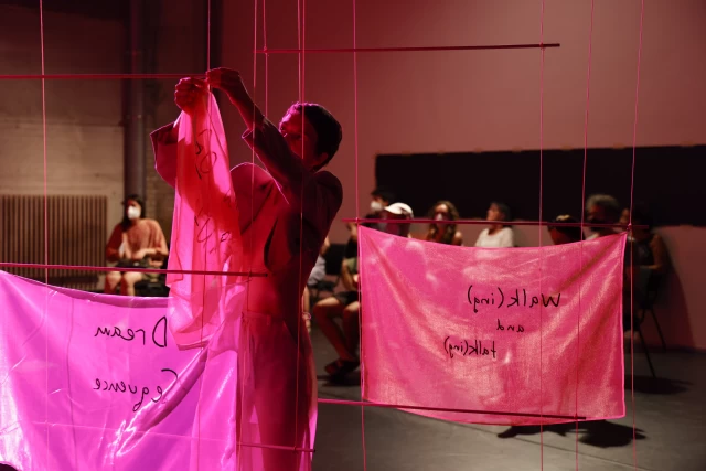 Britta taking down a banner, Tanzfabrik Berlin, June 2021 – photo by Anja Weber