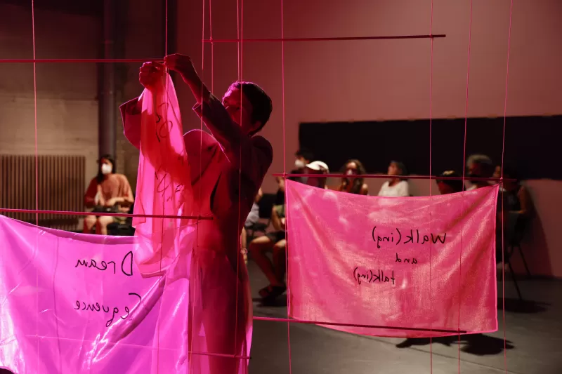 Britta taking down a banner, Tanzfabrik Berlin, June 2021 – photo by Anja Weber